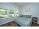 Comfortable bedroom featuring a queen-size bed, hardwood floors, and a large window with a street view at 203 O'Malley Dr, Summerville, SC 29483