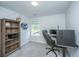 A clean bedroom space, furnished with a desk, bookcase, and large window for natural light at 203 O'Malley Dr, Summerville, SC 29483