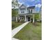 Charming two-story home featuring a welcoming front porch and beautifully landscaped front yard with vibrant green grass at 203 O'Malley Dr, Summerville, SC 29483