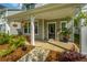 Inviting front porch with decorative plants, seating, and charming details, offering a warm welcome at 203 O'Malley Dr, Summerville, SC 29483
