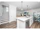 Open kitchen with stainless appliances, white cabinets, island and a view of the staircase at 203 O'Malley Dr, Summerville, SC 29483