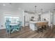 Open kitchen and dining area with white cabinets, island, and a view to the back yard at 203 O'Malley Dr, Summerville, SC 29483
