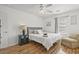 Bright bedroom featuring hardwood floors, a ceiling fan, and a comfortable king-sized bed with soft linens at 2030 Coldspring Dr # 708, North Charleston, SC 29406