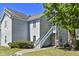 Charming light blue two-story home with wooden siding, stairs to doorway and landscaped yard at 2030 Coldspring Dr # 708, North Charleston, SC 29406