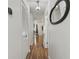 Hallway with hardwood floors and a decorative mirror leading to the dining area at 2030 Coldspring Dr # 708, North Charleston, SC 29406