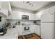 Bright kitchen boasts white cabinets, stainless steel appliances, stylish backsplash, and hardwood floors at 2030 Coldspring Dr # 708, North Charleston, SC 29406