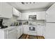 Well-lit kitchen with white cabinets, modern appliances, and an attractive backsplash at 2030 Coldspring Dr # 708, North Charleston, SC 29406
