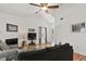 Bright living room features a ceiling fan, fireplace, and access to a balcony with natural light at 2030 Coldspring Dr # 708, North Charleston, SC 29406