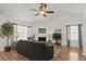 Light-filled living room boasts a ceiling fan, fireplace, and an open layout with hardwood flooring at 2030 Coldspring Dr # 708, North Charleston, SC 29406