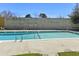A community pool featuring clear water and surrounding vegetation and trees, all under a clear blue sky at 2030 Coldspring Dr # 708, North Charleston, SC 29406