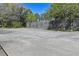 Outdoor community tennis court surrounded by fencing and mature trees at 2030 Coldspring Dr # 708, North Charleston, SC 29406