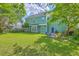 Large backyard with well-kept grass, and multiple trees providing shade, offers an ideal space for outdoor living and entertainment at 219 Silverwood Ln, Summerville, SC 29485