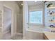 This bathroom features a glass shower, a soaking tub under a bright window, and neutral walls at 219 Silverwood Ln, Summerville, SC 29485