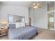 Bright bedroom featuring vaulted ceilings, a ceiling fan, a large mirror, and a plush bed with a neutral color palette at 219 Silverwood Ln, Summerville, SC 29485