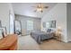 Bright bedroom featuring vaulted ceilings, a ceiling fan, two mirrors and a plush bed with a neutral color palette at 219 Silverwood Ln, Summerville, SC 29485