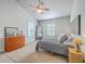 Bright bedroom featuring vaulted ceilings, a ceiling fan, two mirrors and a plush bed with a neutral color palette at 219 Silverwood Ln, Summerville, SC 29485