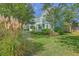 A verdant lawn and mature trees surround the charming two-story home at 219 Silverwood Ln, Summerville, SC 29485