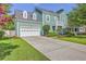 Two-story home with an attached garage and long driveway, showcasing curb appeal at 219 Silverwood Ln, Summerville, SC 29485