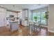 Charming eat-in kitchen featuring white cabinets, stainless appliances, and a cozy breakfast nook with greenery at 219 Silverwood Ln, Summerville, SC 29485