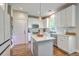 Modern kitchen with white cabinets, stainless steel appliances, and a central island with countertop seating at 219 Silverwood Ln, Summerville, SC 29485