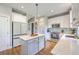 Modern kitchen with white cabinets, stainless steel appliances, and a central island with countertop seating at 219 Silverwood Ln, Summerville, SC 29485