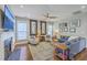 Bright living room boasts hardwood floors, a ceiling fan, comfortable seating, and decorative mirrors at 219 Silverwood Ln, Summerville, SC 29485