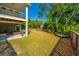 Large backyard featuring a covered patio, large oak trees, and a boat at 2501 Myrtle St, Edisto Beach, SC 29438