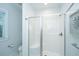 This bathroom features a glass enclosed walk-in shower with a built-in seat and white tiling at 2501 Myrtle St, Edisto Beach, SC 29438