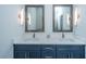 Modern bathroom with double sinks, quartz countertop, framed mirrors, and decorative sconces at 2501 Myrtle St, Edisto Beach, SC 29438