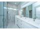 Modern bathroom with dual sinks, sleek fixtures, and a glass-enclosed shower at 2501 Myrtle St, Edisto Beach, SC 29438