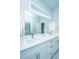 Elegant bathroom featuring a large mirror, contemporary lighting, and double sinks at 2501 Myrtle St, Edisto Beach, SC 29438