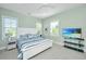 Bright bedroom with a plush bed, ceiling fan, and light-filled windows at 2501 Myrtle St, Edisto Beach, SC 29438