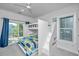 Charming bedroom with bunk beds, balcony access, and natural light creating a relaxing atmosphere at 2501 Myrtle St, Edisto Beach, SC 29438