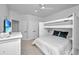 Bright bedroom with a custom built-in bunk bed with a queen bed on the bottom and a twin on top at 2501 Myrtle St, Edisto Beach, SC 29438