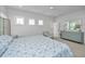 Light-filled bedroom featuring a decorative chair and dresser, complemented by ample natural light at 2501 Myrtle St, Edisto Beach, SC 29438