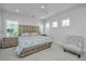 Serene bedroom with a decorative chair and neutral tones, enhanced by natural light at 2501 Myrtle St, Edisto Beach, SC 29438