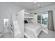 Bright bedroom with a custom built-in bunk bed with a queen bed on the bottom and a twin on top at 2501 Myrtle St, Edisto Beach, SC 29438