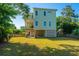 Beautiful two-story home showcasing a spacious yard, covered patio, and charming architectural details at 2501 Myrtle St, Edisto Beach, SC 29438