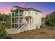 Two-story home with covered porches and stairs leading to the entrance at 2501 Myrtle St, Edisto Beach, SC 29438