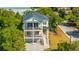 Stunning home with balconies, stairs, a blue roof, and a charming, sunny exterior at 2501 Myrtle St, Edisto Beach, SC 29438
