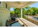 Covered porch with wicker furniture overlooking the front yard at 2501 Myrtle St, Edisto Beach, SC 29438