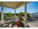 Covered porch featuring outdoor furniture, offering a great view of the lush greenery at 2501 Myrtle St, Edisto Beach, SC 29438