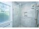 Elegant bathroom shower features stylish gray tile, a built-in niche, and a modern dual shower head at 2501 Myrtle St, Edisto Beach, SC 29438