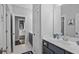 Well-lit bathroom with a double vanity, stylish tiling, and a connecting doorway to the living room at 2522 Daniel Island Dr, Daniel Island, SC 29492