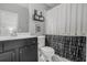 Stylish bathroom features a decorative shower curtain, black vanity, and patterned tile floor at 2522 Daniel Island Dr, Daniel Island, SC 29492