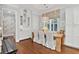 Bright dining area featuring hardwood floors, a rustic wood table, and custom built-in cabinetry for ample storage at 2522 Daniel Island Dr, Daniel Island, SC 29492