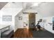 Upstairs exercise room with high vaulted ceilings, hardwood floors, and a stationary bike for at-home workouts at 2522 Daniel Island Dr, Daniel Island, SC 29492