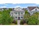 Charming two-story home with double porches, blue shutters, and manicured landscaping offers classic Southern charm at 2522 Daniel Island Dr, Daniel Island, SC 29492