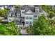Spacious two-story home with a screened porch, side patio, and large palm tree in a manicured yard at 2522 Daniel Island Dr, Daniel Island, SC 29492