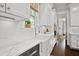 Bright kitchen with white cabinetry and marble countertops provides a sleek and functional cooking space at 2522 Daniel Island Dr, Daniel Island, SC 29492